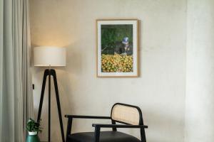 a room with a chair and a picture on the wall at Oculus Bali in Kintamani