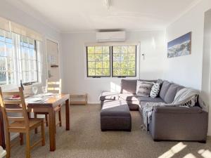 a living room with a couch and a table at Karoonda Lodge in Jindabyne