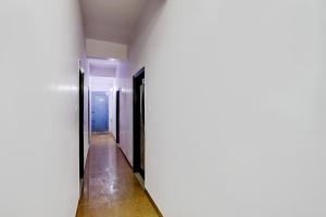 a corridor of an empty room with two doors at OYO Pluto Residency in Ghaziabad
