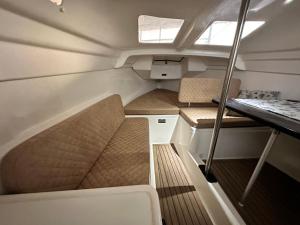 a small boat with two chairs and a table at "Floating Home - Übernachten auf einer Segelyacht im Hafen" in Friedrichshafen