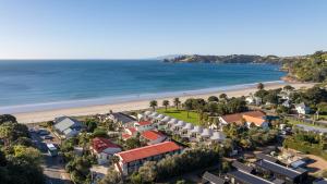 an aerial view of a resort and the beach at Waiata Beach House - Onetangi in Onetangi