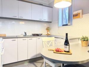 a kitchen with a table with a bottle of wine and a glass at Kirkwood 4A in Thredbo
