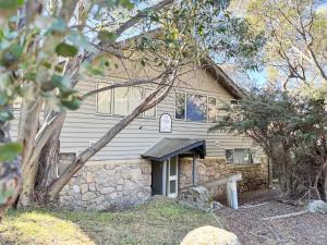 a stone house with a stone wall at Kirkwood 4A in Thredbo