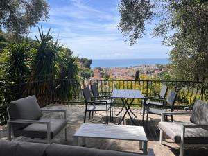 a patio with tables and chairs and a view of the city at Petit paradis perché au coeur de Nice in Nice