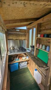 an inside view of a kitchen in a tiny house at Belle Village, non electric ,Rent a bell tent, BEDDING NOT SUPPLIED in Narberth