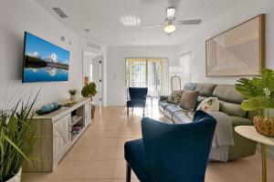 a living room with a couch and a table at Spacious Condo W/ Pool,Gym near Disney & Seaworld in Kissimmee