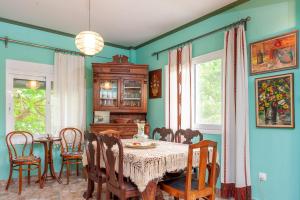 a dining room with a table and chairs at Stavros summer house in Nea Fokea