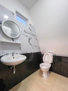 a bathroom with a sink and a toilet and a mirror at บ้านสวนพระคุณพ่อ-แม่ in Udon Thani +18 photos