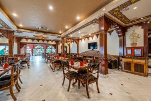 a dining room with wooden tables and chairs at Chokhi Dhani The Ethnic 5-Star Deluxe Resort in Jaipur