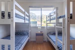 two bunk beds in a room with a window at Unbeatable Waterfront Location in Sussex Inlet