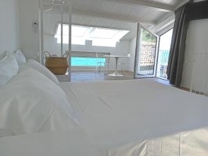 A bed or beds in a room at Dolce Dimora Charme Mare