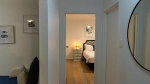 a bedroom with a bed and a mirror on the wall at Gidgets on Gretel in Nelson Bay