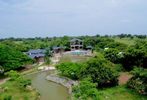 an aerial view of a house with a pond at Arbor Road Estate in Pāmalparti