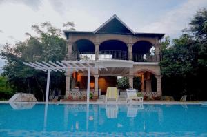a house with a swimming pool in front of it at Arbor Road Estate in Pāmalparti