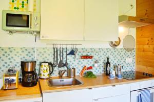 a kitchen counter with a sink and a microwave at Augenweide in Prien am Chiemsee