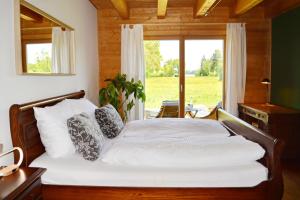 a bedroom with a large bed with a window at Augenweide in Prien am Chiemsee