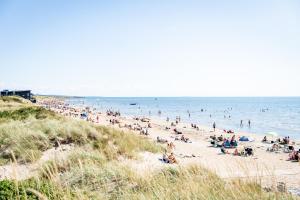 a large crowd of people on a beach at Lilla Fajans in Falkenberg