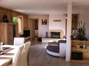 a large living room with a couch and a bed at Chalet avec vue panoramique sur les Montagnes du Mole et la chaîne des Aravis piscine chauffée à 5 min des pistes de la station des Brasses in Viuz-en-Sallaz