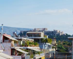 a group of buildings on top of a mountain at Gtrip Gazi Duplex Apartment - 33701 in Athens