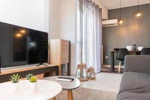 a living room with a large flat screen tv at Gtrip Gazi Duplex Apartment - 33701 in Athens