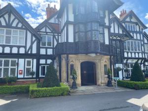 a large black and white building with a door at Hare Lodge in Woodhall Spa