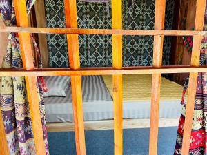 Làng Cac的住宿－Du Già Coffee View Homestay，配有窗帘的客房内的一张木制双层床