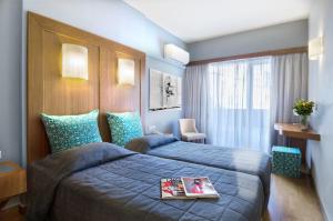 Postel nebo postele na pokoji v ubytování Hermes Hotel