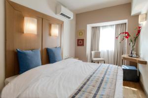 Postel nebo postele na pokoji v ubytování Hermes Hotel