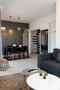 a living room with a couch and a table at Gtrip Gazi Duplex Apartment - 33701 in Athens
