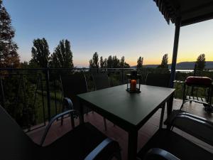 a table and chairs on a balcony with a view at Levendulás in Szigliget +15 photos