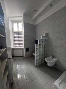 a white bathroom with a sink and a toilet at Piotrkowska Off Family Apart in Łódź
