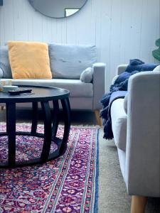 a living room with a couch and a coffee table at Cosy Coastal Villa in Lyall Bay in Wellington