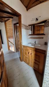 a kitchen with a sink and wooden cabinets at Safari Village - Case73 in Saly Portudal