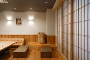 a living room with a couch and a table at Hotel Bauhinia in Shinano