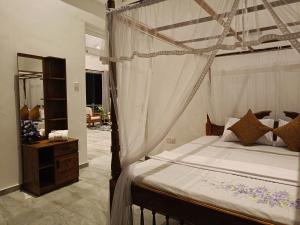 a bedroom with a canopy bed in a room at 259 Residencies in Kandy
