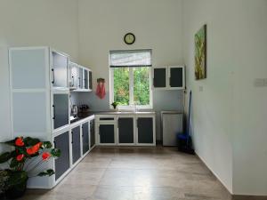 a kitchen with white cabinets and a window at 259 Residencies in Kandy