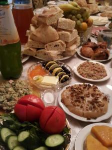 a table full of different types of food on plates at Guest House Vivaushba in Bagvdanari +63 photos
