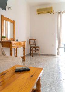 a living room with a couch and a table at Ermioni Rooms in Paralia Vrachou