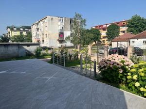 a walkway in a city with buildings and flowers at Apartman Scepanovic 2 in Nikšić