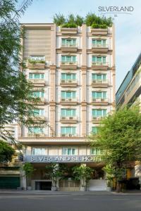 een hoog gebouw met een bord ervoor bij Silverland Sil Hotel in Ho Chi Minh-stad