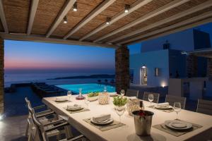 a dining room with a table and a view of the ocean at TLuxuryvilla in Parikia