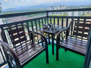 a cat sitting on a table on a balcony at Idea Homestay 2 in Ipoh