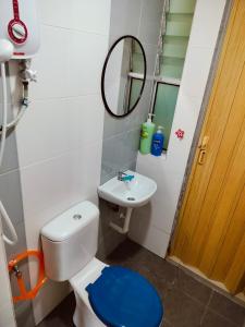 a bathroom with a toilet and a sink and a mirror at Idea Homestay 2 in Ipoh +15 photos