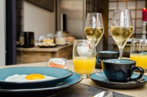 a table topped with plates of food next to a glass of orange juice at B&B Le Foulage in Bruges