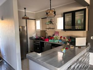a kitchen with a counter top and a refrigerator at Bait Karim - Twin Villa with roof & juccuzi in Ras Elhekma