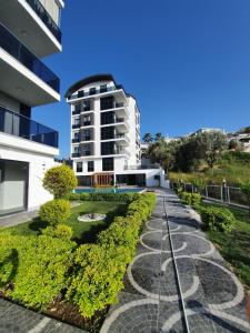 a walkway in front of a building at Dreamy luxury two-bedroom penthouse apartment with special forest, mountain and sea views in Alanya