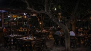 people sitting at tables in a restaurant at night at Sheriff, Olympos in Kumluca
