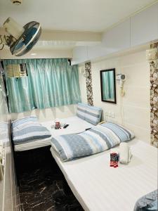 Habitación con 2 camas en una habitación en Holland Guest House, en Hong Kong