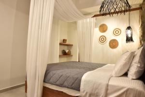 a bedroom with a bed with a canopy at Rafael Hotel-Adults Only in Lindos