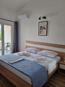 a bedroom with a large bed with a blue blanket at Bed and Breakfast MIRAMAR in Starigrad